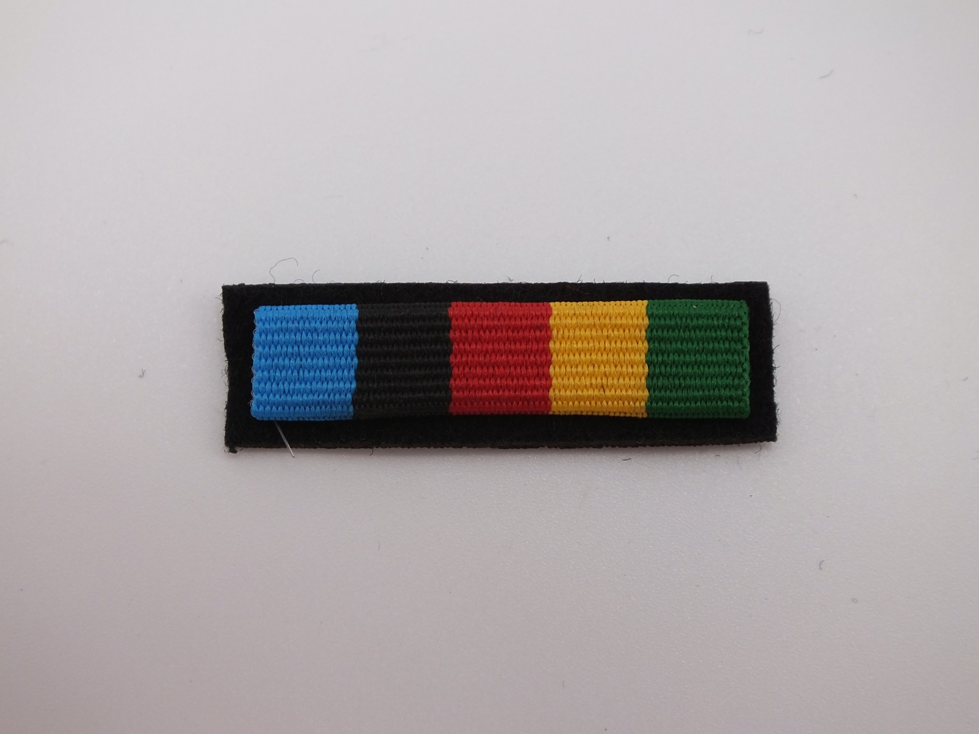 Baretka Medal 60 Lat Udziału Polski w Misjach Poza Granicami Państwa